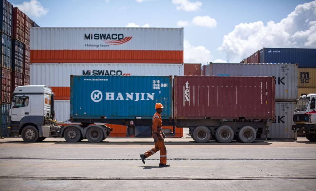 A prime mover hauling a 40ft container past stacked containers at the Port of Mombasa